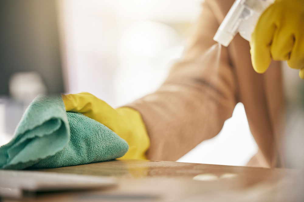 Someone cleaning a surface