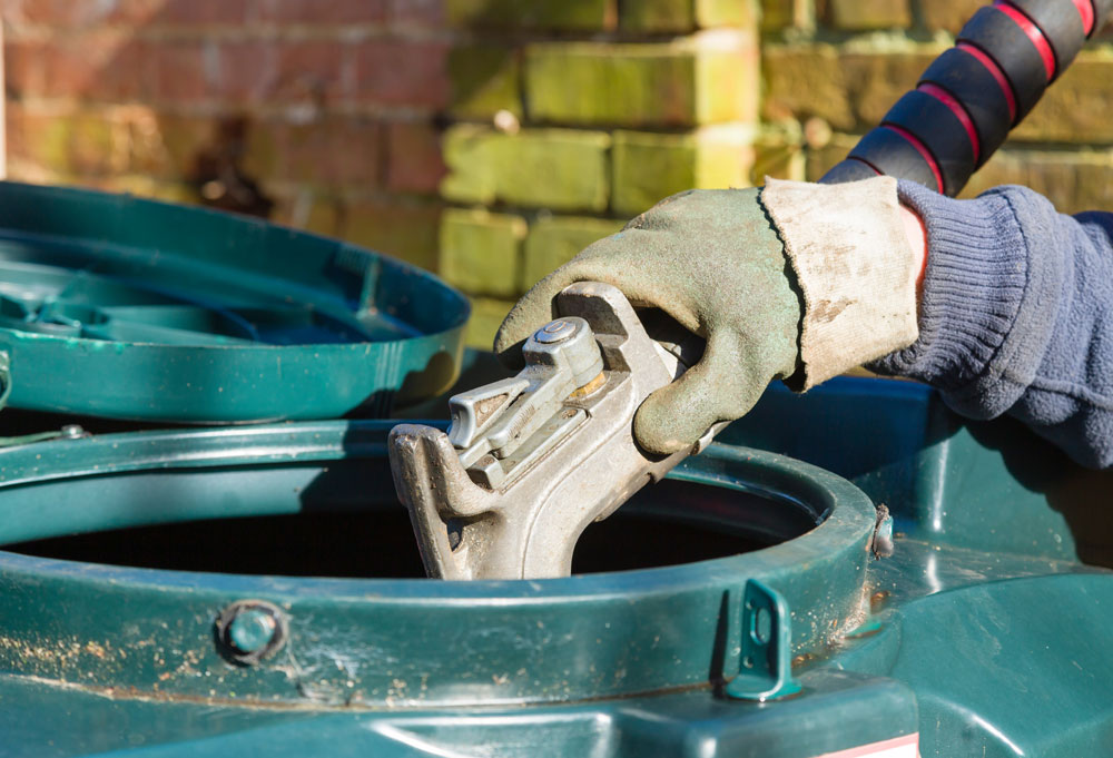 Someone filling a heating oil tank