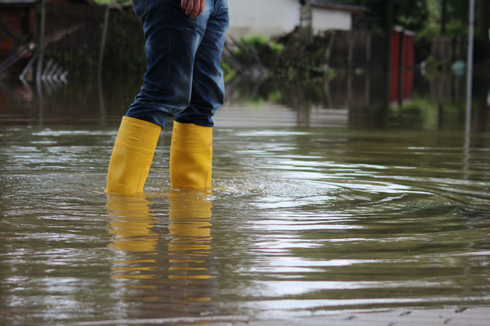 Someone wading through floodwater