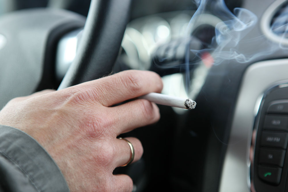 Driver smoking cigarette in a car