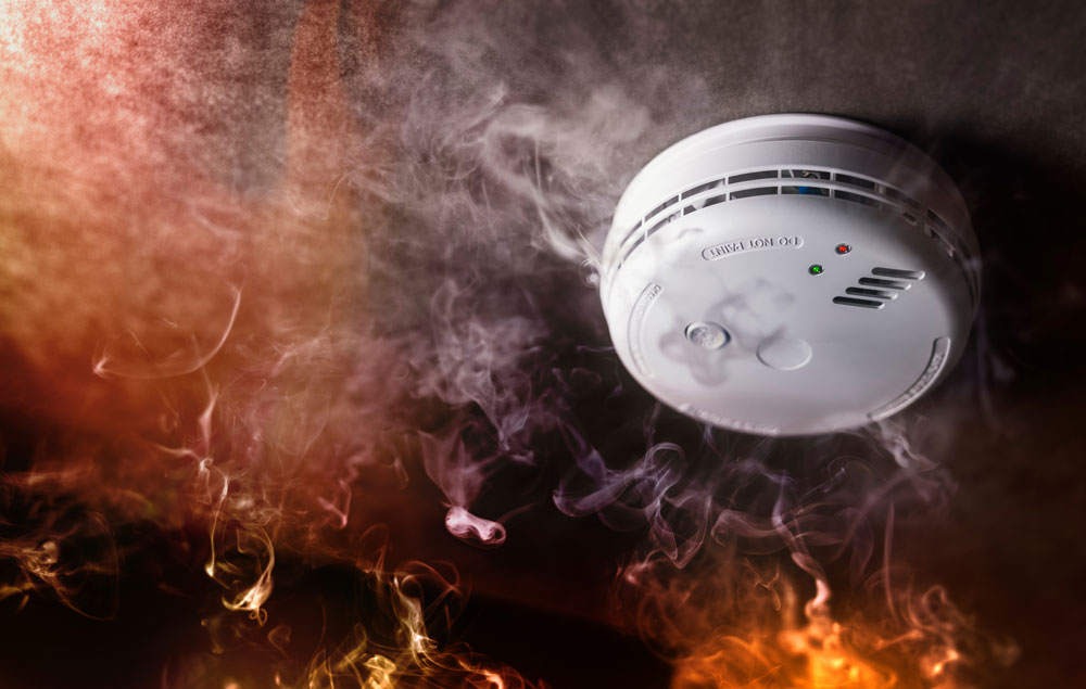 fire and smoke near a smoke detector