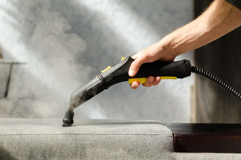 Steam cleaning a piece of furniture