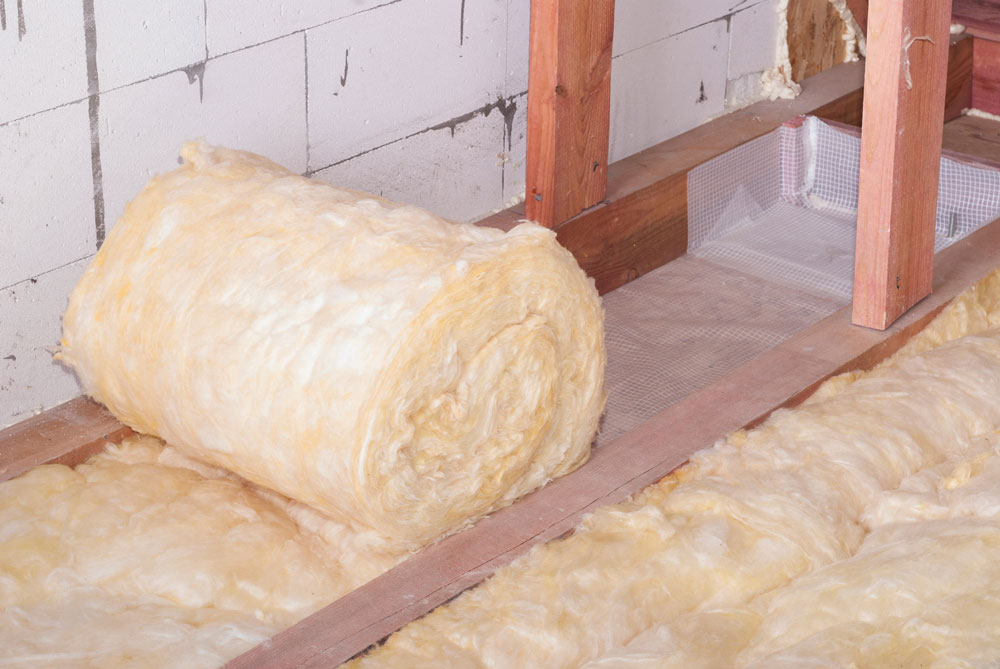 Insulation roll being installed in a loft