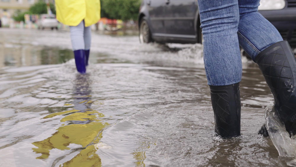 People walking through flood water