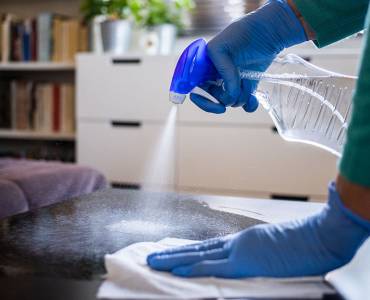 Cleaner spraying a surface