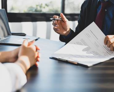 A solicitor and client signing paperwork