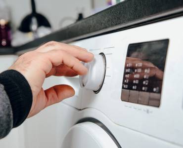 Someone using a tumble dryer