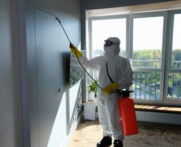A specialist cleaner decontaminating a room