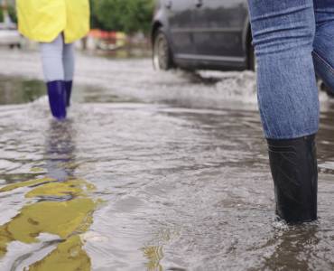 People walking through flood water